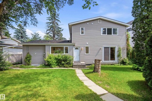 Light gray siding exterior with a dark shingle roof - 14335 47 Avenue Nw, Edmonton, AB - Outdoor