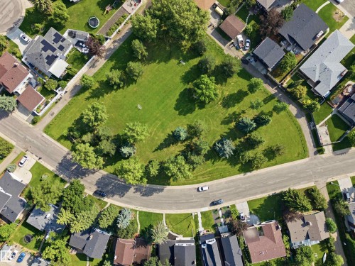 Expansive green space featuring mature trees and open lawn areas, bordered by residential properties - 14335 47 Avenue Nw, Edmonton, AB -  With View