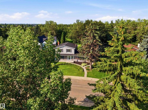 Traditional-style residence featuring grey siding with dark shutters, a dark roof, and a prominent front porch - 14335 47 Avenue Nw, Edmonton, AB - Outdoor