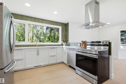 Modern kitchen featuring light wood-finish flooring and white walls - 14335 47 Avenue Nw, Edmonton, AB - Indoor Photo Showing Kitchen