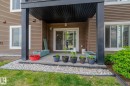 Covered patio featuring concrete flooring and a sliding glass door entry - #107 142 Ebbers Bv Nw, Edmonton, AB  - Outdoor 