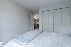 Bedroom featuring neutral wall paint, white trim, and bi-fold closet doors with round chrome hardware - 