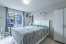 Bright room featuring a large window, soft neutral wall color, and light-toned carpet flooring - #107 142 Ebbers Bv Nw, Edmonton, AB  - Indoor Photo Showing Bedroom 