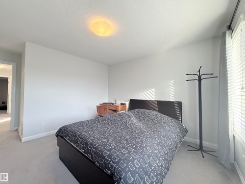Light-colored carpeting and walls with a flush-mount ceiling light fixture - 5876 168 Avenue Nw, Edmonton, AB - Indoor Photo Showing Bedroom