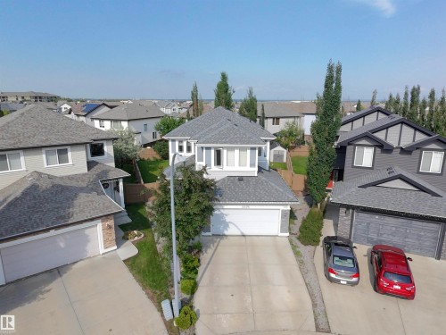 Contemporary two-story residence featuring a light gray exterior, white trim, and a gray shingle roof - 5876 168 Avenue Nw, Edmonton, AB - Outdoor With Facade