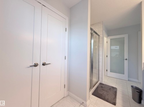 White paneled double doors with brushed nickel hardware - 5876 168 Avenue Nw, Edmonton, AB - Indoor Photo Showing Other Room