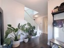 Entryway featuring dark wood-finish flooring, a contemporary staircase with glass panel railing, and recessed ceiling lighting - 5876 168 Avenue Nw, Edmonton, AB  - Indoor Photo Showing Other Room 