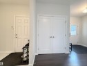 Dual white panel doors with brushed nickel hardware - 5876 168 Avenue Nw, Edmonton, AB  - Indoor Photo Showing Other Room 