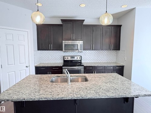7819 173 Avenue, Edmonton, AB - Indoor Photo Showing Kitchen With Stainless Steel Kitchen With Double Sink With Upgraded Kitchen
