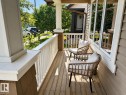 Inviting front porch featuring wood flooring, white railing, and shake siding accents - 3457 Cutler Crescent Sw, Edmonton, AB  - Outdoor With Deck Patio Veranda With Exterior 