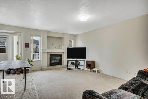3135 34B Avenue Nw, Edmonton, AB - Indoor Photo Showing Living Room With Fireplace