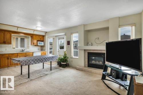 3135 34B Avenue Nw, Edmonton, AB - Indoor Photo Showing Living Room With Fireplace