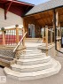 Multi-tiered wooden deck entry with a shingled roof overhang - 610 8 Avenue, Wainwright, AB  - Outdoor With Deck Patio Veranda With Exterior 