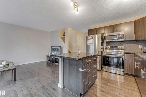 #10 5101 Soleil Bv, Beaumont, AB - Indoor Photo Showing Kitchen With Stainless Steel Kitchen