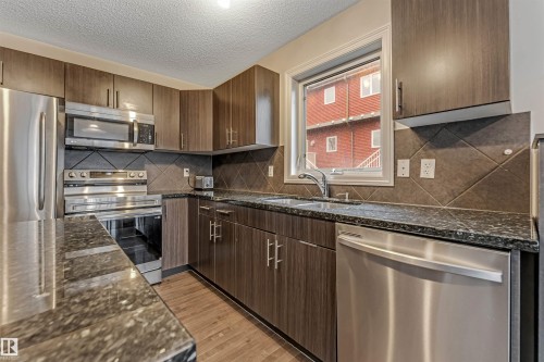 #10 5101 Soleil Bv, Beaumont, AB - Indoor Photo Showing Kitchen With Stainless Steel Kitchen With Double Sink