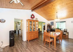 Vaulted wood-paneled ceiling with exposed beam - 