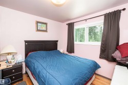 Light wood-finish flooring complements the room's soft pink walls - 