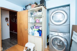 Dedicated laundry area featuring a stacked washer and dryer unit - 