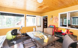 Room with wood-finish flooring and a natural wood plank ceiling - 