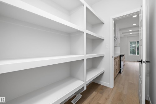 Built-in white shelving system with multiple tiers - 919 Elderberry Landing Nw, Edmonton, AB - Indoor With Storage