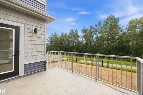 Outdoor balcony featuring a gray textured floor and metal railing - 919 Elderberry Landing Nw, Edmonton, AB - Outdoor With Exterior