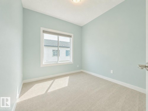 Room featuring light blue walls and beige carpet flooring - #56 804 Welsh Dr Sw, Edmonton, AB - Indoor Photo Showing Other Room