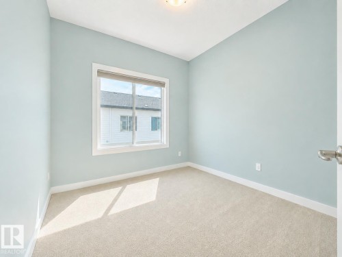 Light blue walls, white trim, and neutral carpet - #56 804 Welsh Dr Sw, Edmonton, AB - Indoor Photo Showing Other Room