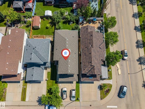 Property with a gray shingled roof and concrete driveway - 16205 55 Street Nw, Edmonton, AB - Outdoor With View