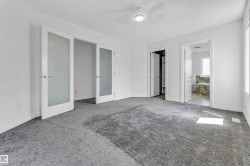 Spacious room with gray carpeting and white walls - 