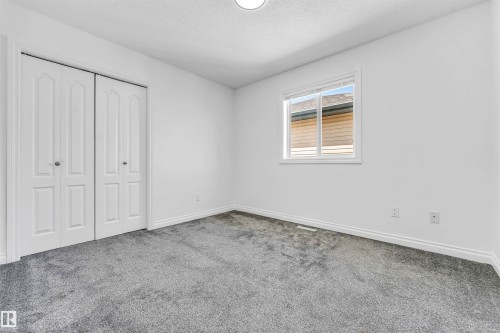 Room featuring neutral gray carpeting and white walls - 16205 55 Street Nw, Edmonton, AB - Indoor Photo Showing Other Room