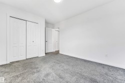 Neutral white wall finishes, crisp white trim, and bi-fold closet doors - 