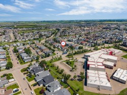 Aerial perspective of a residential neighborhood with paved streets and established homes - 
