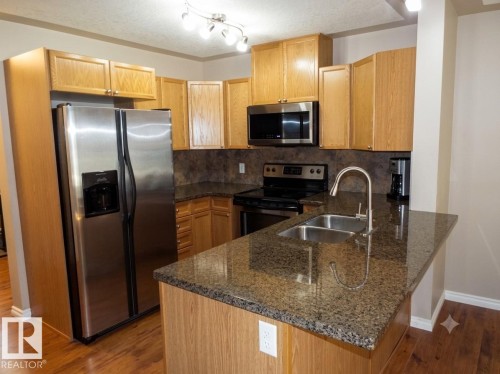 #133 5420 Grant Macewan Bv, Leduc, AB - Indoor Photo Showing Kitchen With Stainless Steel Kitchen With Double Sink
