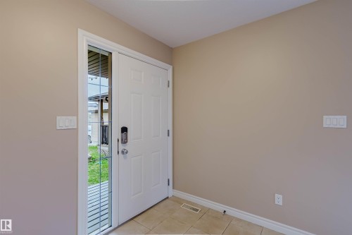 Entryway featuring a paneled door with a digital lock and a full-light sidelite - 1919 Hammond Place, Edmonton, AB - Indoor Photo Showing Other Room