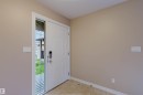 Entryway featuring a paneled door with a digital lock and a full-light sidelite - 1919 Hammond Place, Edmonton, AB  - Indoor Photo Showing Other Room 