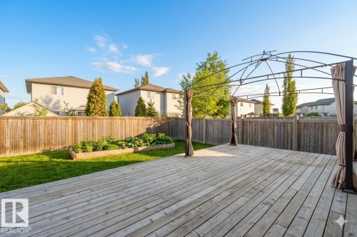 Expansive wood deck featuring a gazebo frame with privacy drapes - 1919 Hammond Place, Edmonton, AB - Outdoor With Deck Patio Veranda