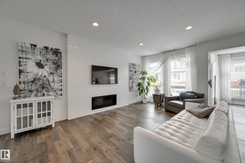 1311 Hainstock Way Sw, Edmonton, AB - Indoor Photo Showing Living Room With Fireplace