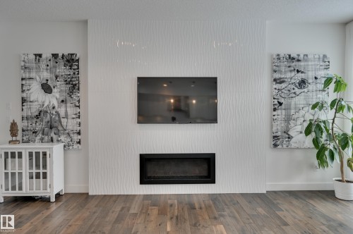 1311 Hainstock Way Sw, Edmonton, AB - Indoor Photo Showing Living Room With Fireplace