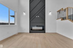 Tall ceilings highlight the vertical dark accent wall with a linear fireplace - 