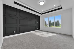 Accent wall featuring black wainscoting with panel molding - 