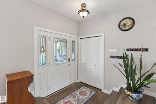 Entryway featuring a white door with decorative glass inserts and two sidelights - 10 Abbey Crescent, St. Albert, AB - Indoor Photo Showing Other Room