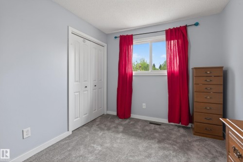 Room featuring light gray walls, gray carpet, and a large window with white trim - 10 Abbey Crescent, St. Albert, AB - Indoor