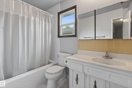 Bathroom featuring a white vanity with an integrated sink, chrome faucet, and a wall-mounted mirrored cabinet - 10 Abbey Crescent, St. Albert, AB - Indoor Photo Showing Bathroom