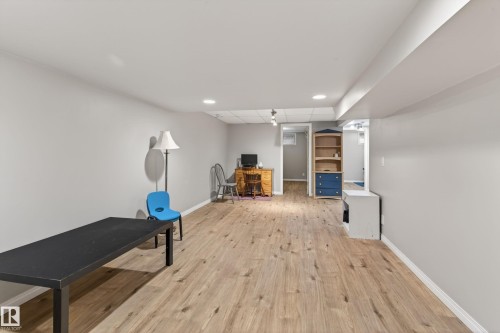 Spacious room featuring wood-finish flooring, light gray walls, and recessed lighting - 10 Abbey Crescent, St. Albert, AB - Indoor Photo Showing Other Room