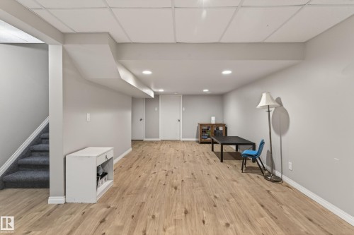 Finished lower level featuring wood-finish flooring, recessed lighting, and a drop ceiling - 10 Abbey Crescent, St. Albert, AB - Indoor Photo Showing Other Room