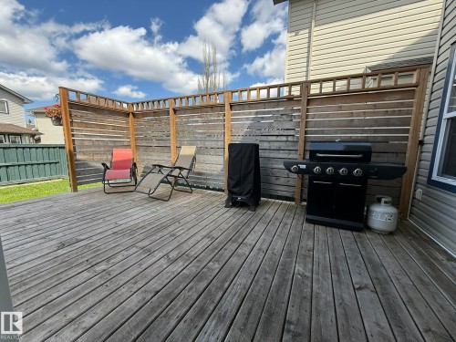 Spacious wooden deck with slatted wood privacy fencing - 1820 Robertson Crescent Sw, Edmonton, AB - Outdoor With Deck Patio Veranda