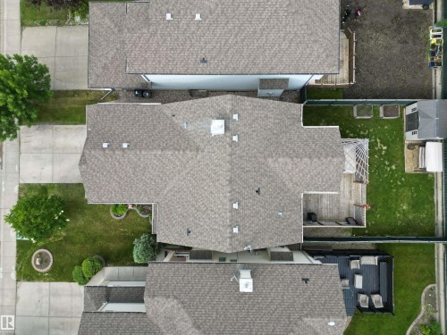 Property featuring a multi-gabled roof, rear wood deck, and a grass lawn - 1820 Robertson Crescent Sw, Edmonton, AB - Outdoor