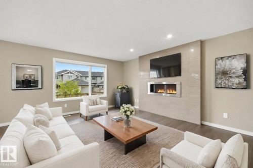 (virtually staged furniture) - 3528 Claxton Crescent Sw, Edmonton, AB - Indoor Photo Showing Living Room With Fireplace