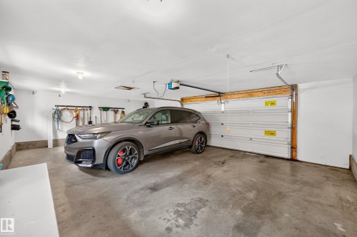 Triple w/ double size door - 6716 101A Avenue Nw, Edmonton, AB - Indoor Photo Showing Garage