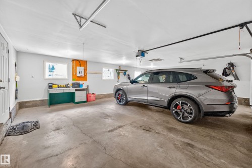 Triple w/ double size door - 6716 101A Avenue Nw, Edmonton, AB - Indoor Photo Showing Garage
